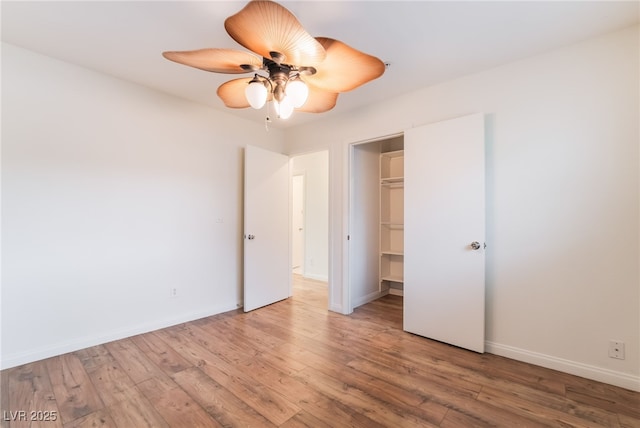 unfurnished bedroom featuring a ceiling fan, baseboards, and wood finished floors