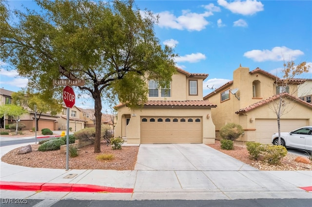 mediterranean / spanish-style house with a garage, a tiled roof, concrete driveway, and stucco siding