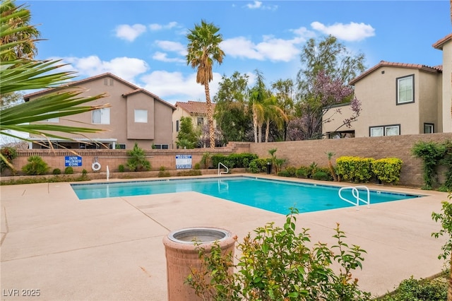 pool featuring a patio area and fence