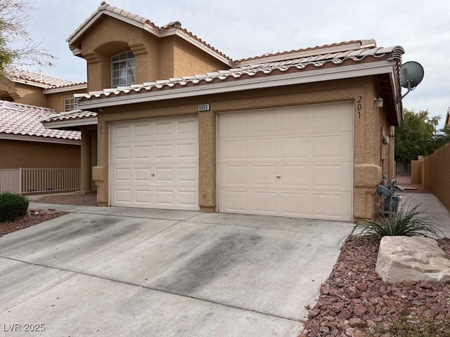 view of front of home featuring driveway, fence, and stucco siding