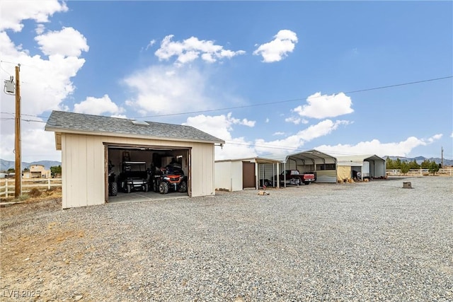 view of outbuilding with a detached carport and an outdoor structure