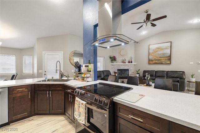 kitchen featuring a sink, light countertops, island exhaust hood, and stainless steel appliances