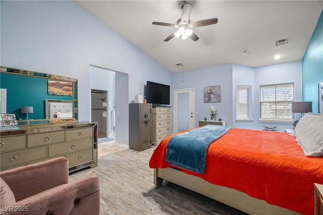 bedroom featuring light wood finished floors, visible vents, ceiling fan, and vaulted ceiling