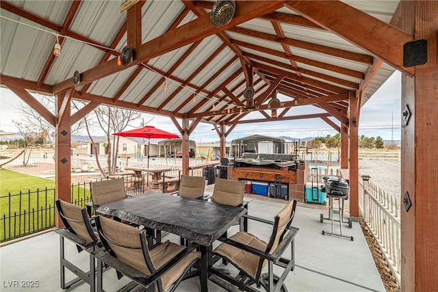 view of patio with outdoor dining space and fence