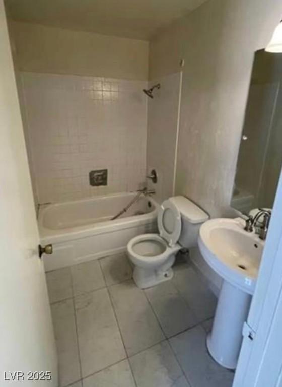 bathroom with toilet, shower / bath combination, and tile patterned flooring