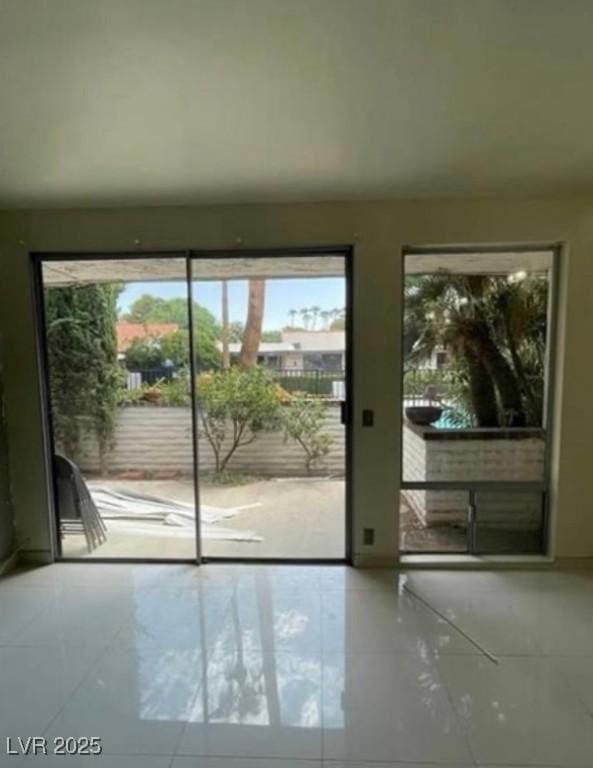 doorway to outside featuring tile patterned flooring