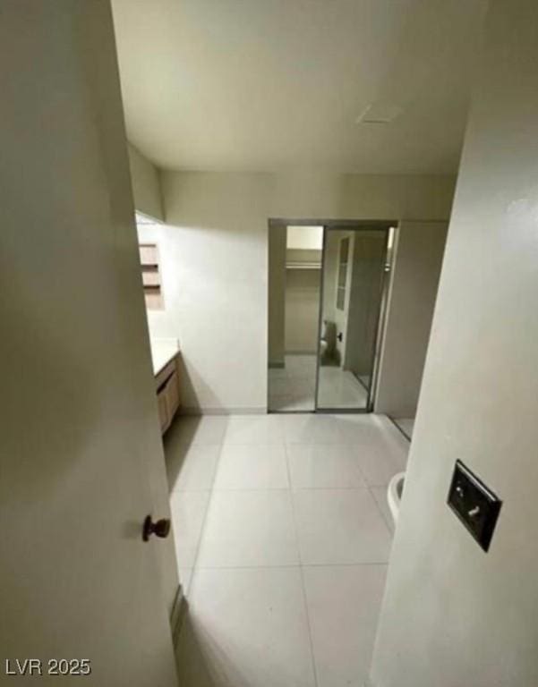 full bathroom with a stall shower, tile patterned flooring, and vanity