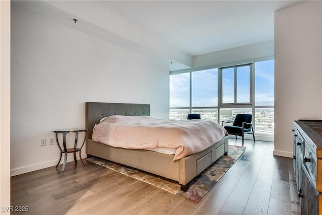 bedroom with wood finished floors and baseboards