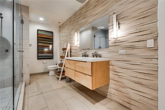 full bath featuring baseboards, toilet, tile patterned flooring, vanity, and a shower stall