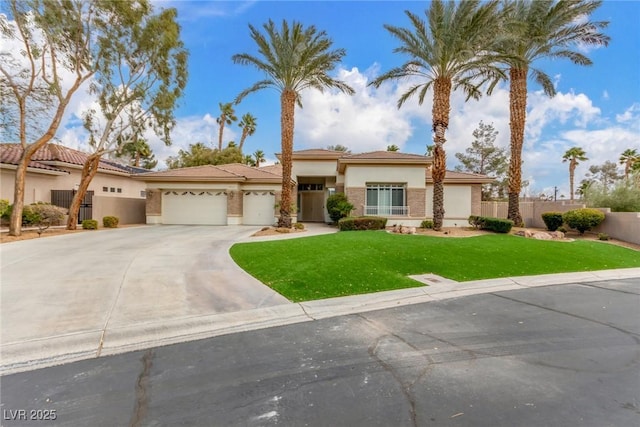 view of front of house featuring stucco siding, concrete driveway, fence, a garage, and a front lawn