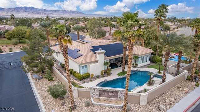 pool featuring a patio area, a fenced backyard, a gate, and a mountain view