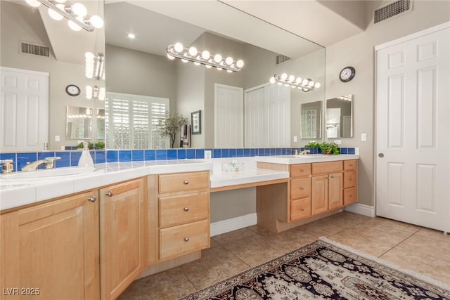 bathroom with vanity, visible vents, and tile patterned floors