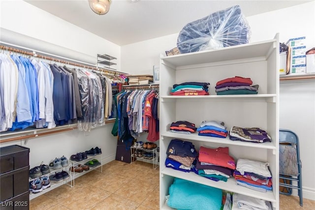 walk in closet with tile patterned flooring