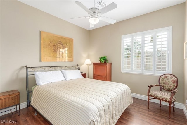 bedroom featuring ceiling fan, wood finished floors, visible vents, and baseboards