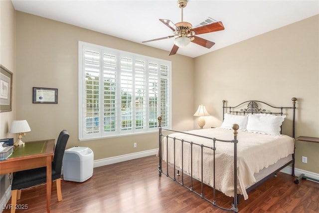 bedroom with ceiling fan, baseboards, and wood finished floors