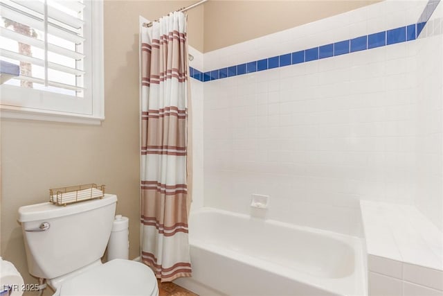 full bath with toilet and shower / bath combo with shower curtain