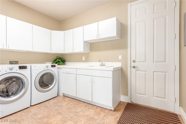 laundry room featuring light tile patterned floors, separate washer and dryer, a sink, and cabinet space