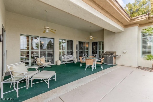 view of patio featuring a grill, a ceiling fan, and outdoor dining space