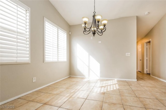 spare room featuring baseboards, a notable chandelier, and light tile patterned flooring