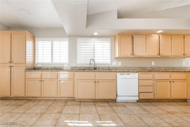 kitchen featuring a wealth of natural light, white dishwasher, a sink, and light brown cabinetry