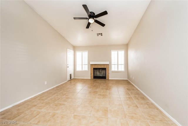 unfurnished living room with baseboards, visible vents, a ceiling fan, lofted ceiling, and light tile patterned flooring