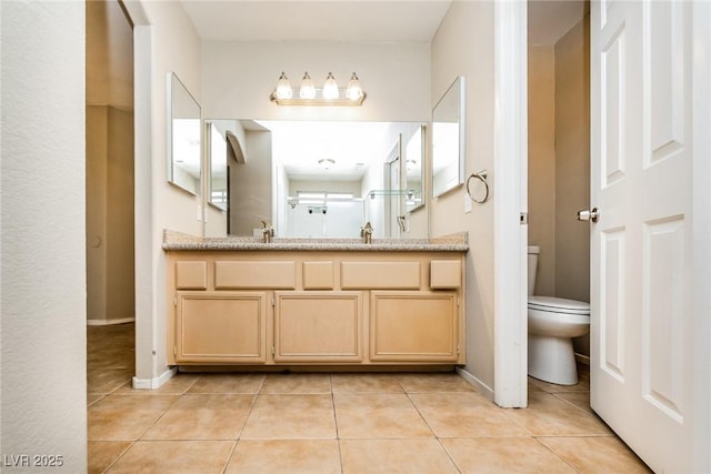 full bath featuring a sink, tile patterned flooring, and toilet