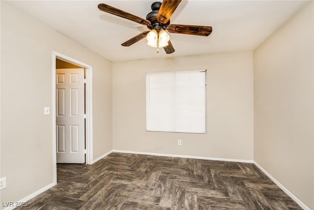 unfurnished room with ceiling fan and baseboards