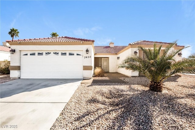 mediterranean / spanish-style house featuring a garage, a tile roof, concrete driveway, and stucco siding