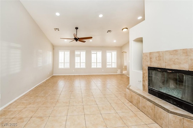 unfurnished living room with a tile fireplace, visible vents, recessed lighting, and light tile patterned floors