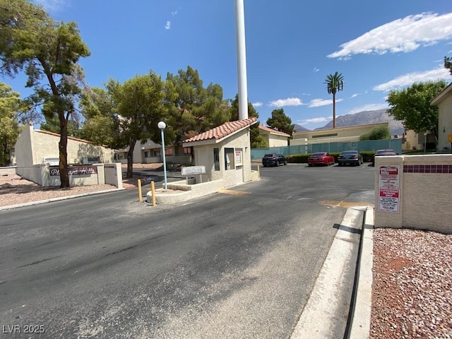 view of street featuring street lights and curbs