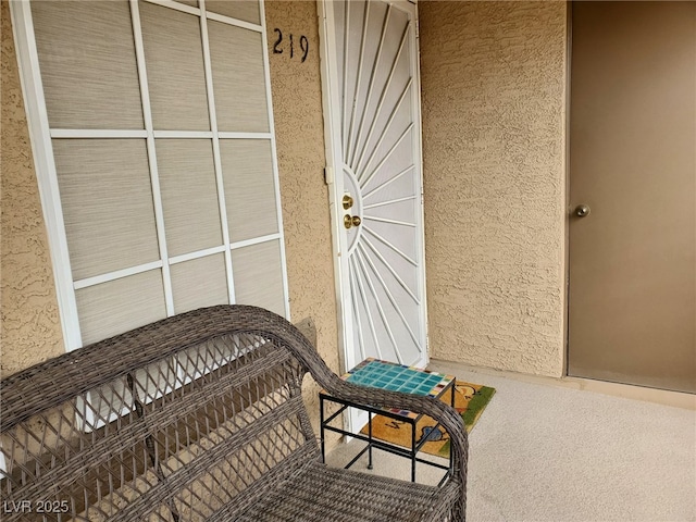 property entrance featuring stucco siding