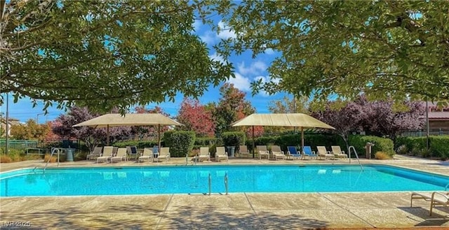 pool featuring fence and a patio