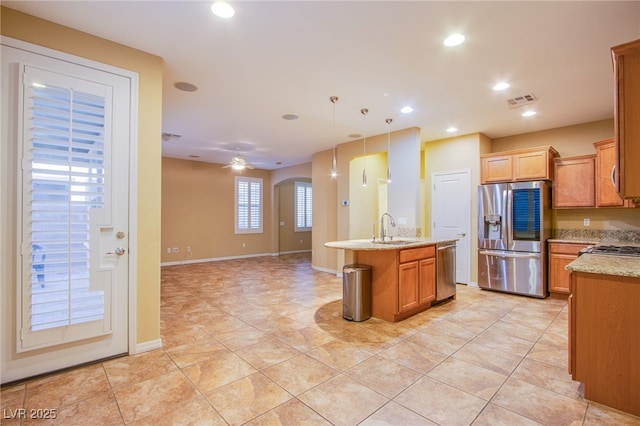 kitchen featuring arched walkways, ceiling fan, recessed lighting, a sink, and appliances with stainless steel finishes