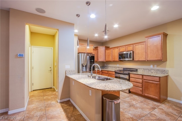 kitchen with stainless steel appliances, a peninsula, a sink, light stone countertops, and pendant lighting