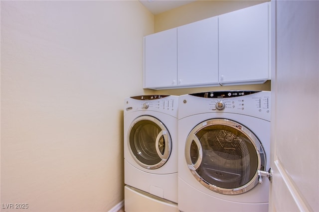 laundry area featuring washing machine and dryer and cabinet space