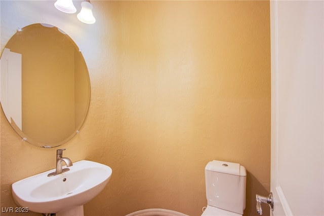 half bathroom with a sink and toilet