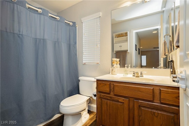 full bathroom with toilet, wood finished floors, and vanity