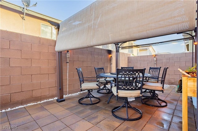 view of patio with fence and outdoor dining space