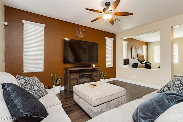 living area with ceiling fan, dark wood finished floors, visible vents, and baseboards