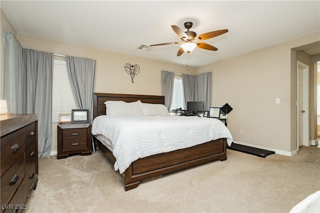 bedroom with a ceiling fan, light colored carpet, visible vents, and baseboards