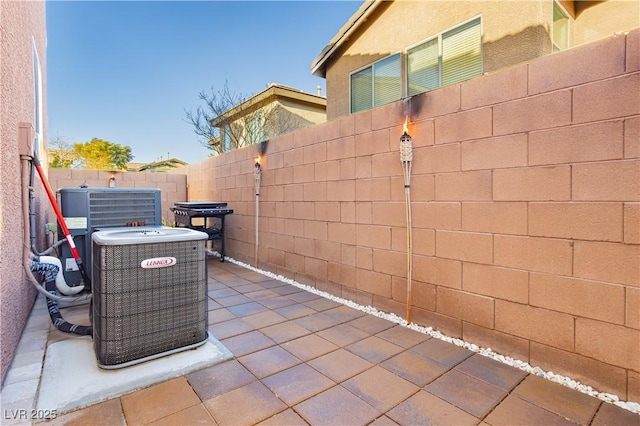 view of patio featuring central AC unit and a fenced backyard