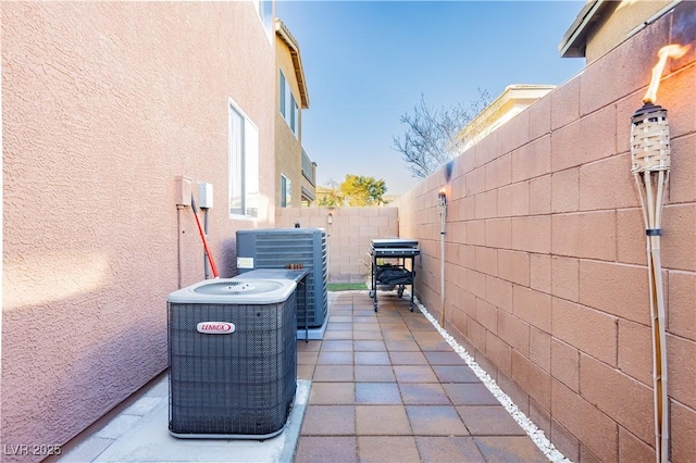 view of patio / terrace with a fenced backyard and central air condition unit