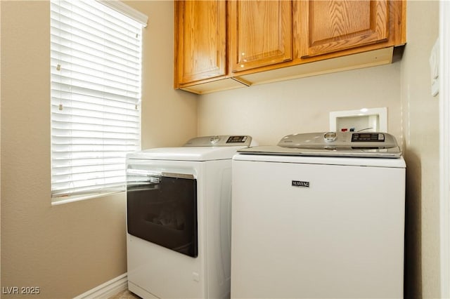 laundry room with washing machine and dryer and cabinet space