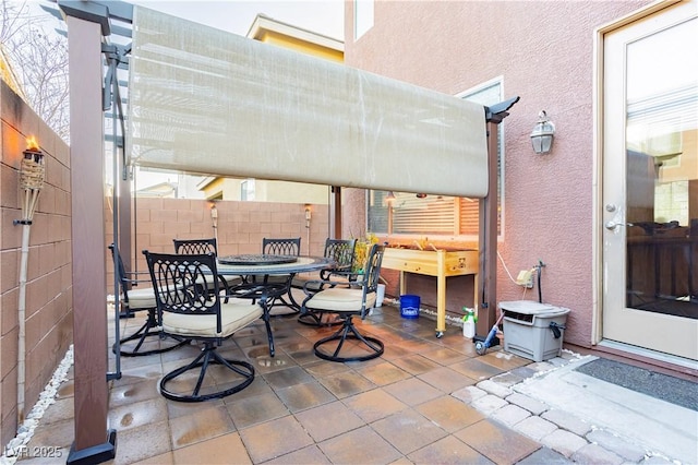 view of patio / terrace with outdoor dining area and fence