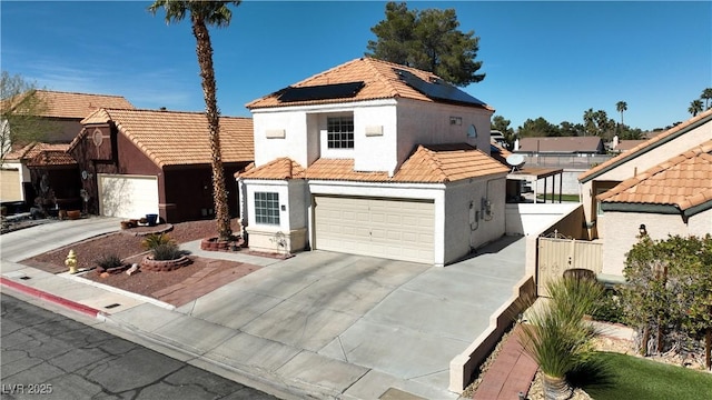 view of front of house featuring a garage, a tiled roof, driveway, and stucco siding