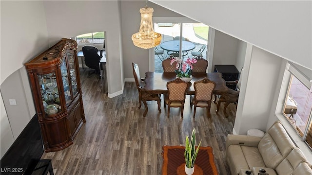 dining space featuring baseboards and dark wood-style flooring