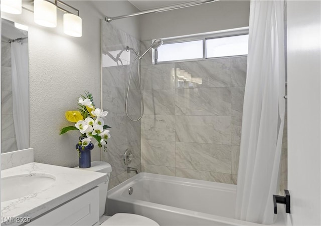 bathroom with a textured wall, vanity, toilet, and shower / tub combo with curtain