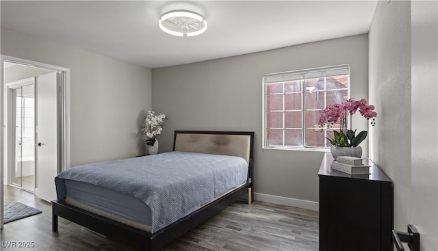 bedroom with wood finished floors and baseboards