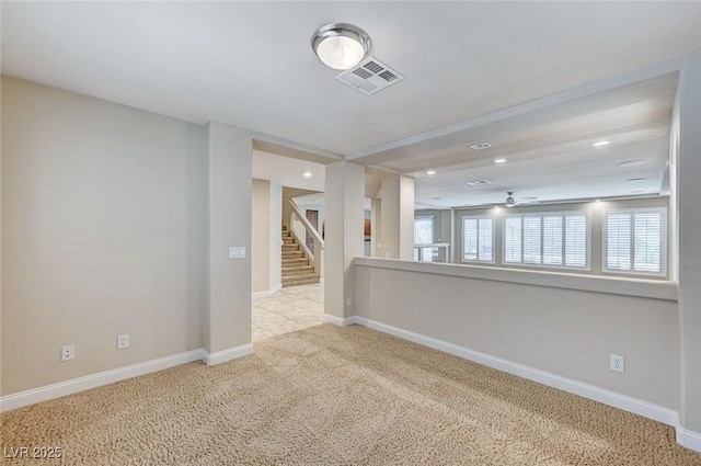 carpeted empty room with stairway, baseboards, visible vents, and recessed lighting