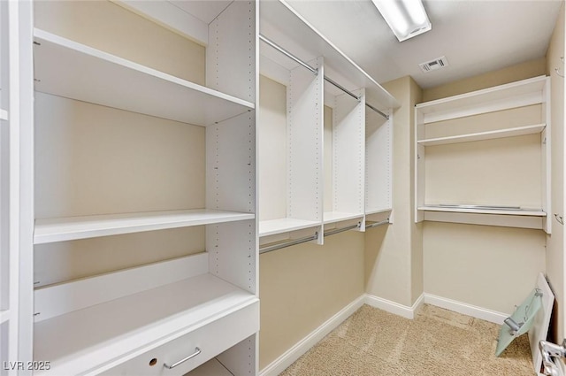 spacious closet with visible vents and carpet flooring